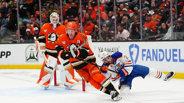 Apr 30, 2026; Anaheim, California, USA; Anaheim Ducks defenseman Jackson LaCombe (2) skates with the puck against Edmonton Oilers center Matt Savoie (22) in the first period of game six of the first round of the 2026 Stanley Cup Playoffs at Honda Center. Mandatory Credit: Kirby Lee-Imagn Images