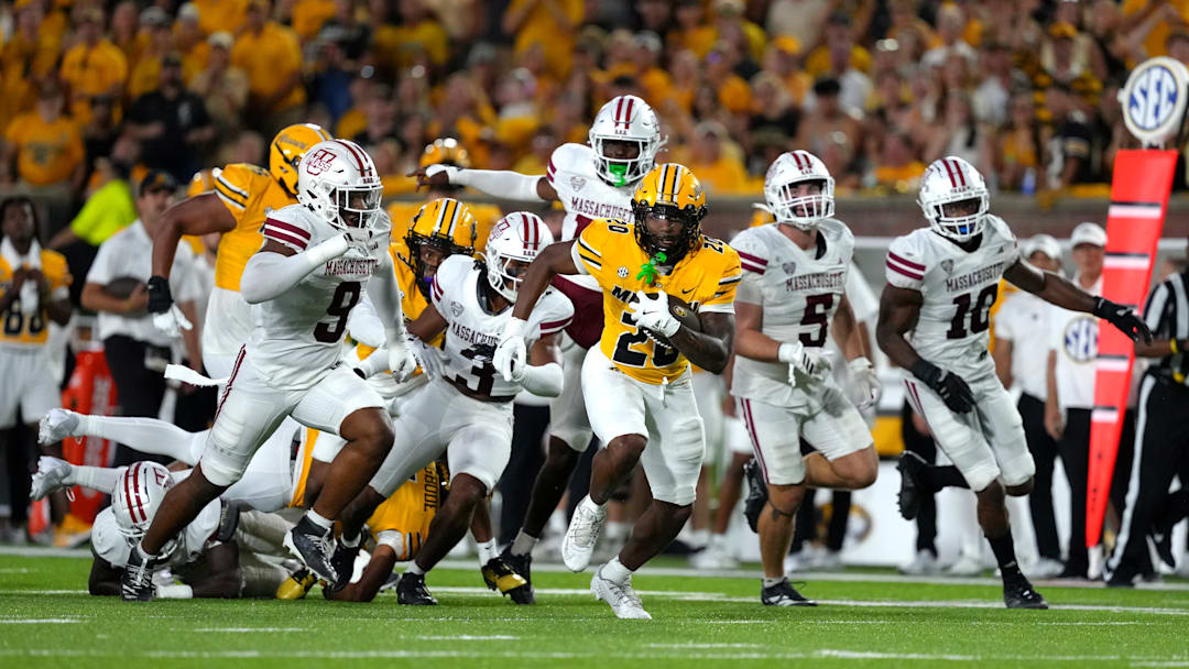 Missouri Tigers running back Ahmad Hardy (29) runs away from several defenders, in a game versus the UMass Minutemen this season.