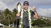 January 12, 2025; Honolulu, Hawaii, USA; Nick Taylor celebrates with the trophy during the final round of the Sony Open golf tournament at Waialae Country Club. Mandatory Credit: Kyle Terada-Imagn Images