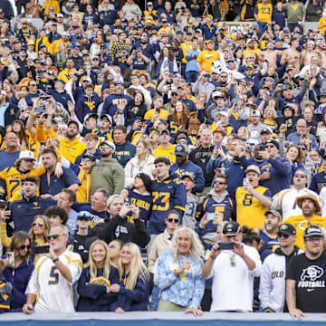 Nov 8, 2025; Morgantown, West Virginia, USA; West Virginia Mountaineers fans sing “Country Roads” after defeating the Colorado Buffaloes at Milan Puskar Stadium. Mandatory Credit: Ben Queen-Imagn Images