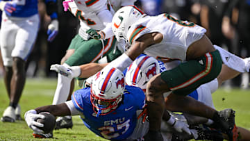 Nov 1, 2025; Dallas, Texas, USA;  SMU Mustangs running back T.J. Harden (27) dives for the goal line during the overtime period against the Miami Hurricanes at Gerald J. Ford Stadium. Mandatory Credit: Jerome Miron-Imagn Images