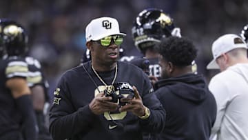 Dec 28, 2024; San Antonio, TX, USA; Colorado Buffaloes head coach Deion Sanders walks on the field between plays during the first quarter against the Brigham Young Cougars at Alamodome. Mandatory Credit: Troy Taormina-Imagn Images