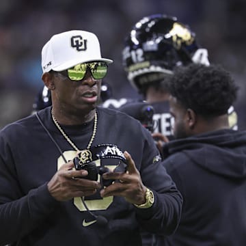 Dec 28, 2024; San Antonio, TX, USA; Colorado Buffaloes head coach Deion Sanders walks on the field between plays during the first quarter against the Brigham Young Cougars at Alamodome. Mandatory Credit: Troy Taormina-Imagn Images