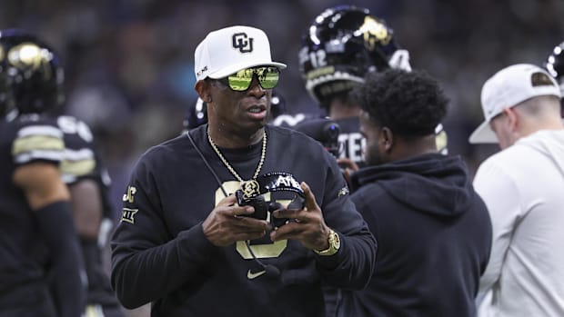 Colorado Buffaloes head coach Deion Sanders walks on the field between plays during the first quarter against the Brigham You