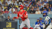 Sep 30, 2025; Los Angeles, California, USA; Cincinnati Reds second baseman Matt McLain (9) hits a double during the third inning against the Los Angeles Dodgers during game one of the Wildcard round for the 2025 MLB playoffs at Dodger Stadium. Mandatory Credit: Jayne Kamin-Oncea-Imagn Images