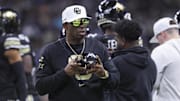 Dec 28, 2024; San Antonio, TX, USA; Colorado Buffaloes head coach Deion Sanders walks on the field between plays during the first quarter against the Brigham Young Cougars at Alamodome. 