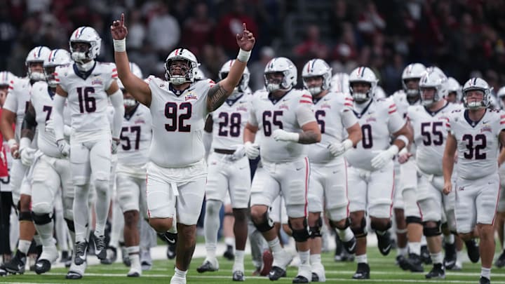 Dec 28, 2023; San Antonio, TX, USA; Arizona Wildcats defensive lineman Tyler Manoa (92) leads the team out ahead of the game against the Oklahoma Sooners at Alamodome. Mandatory Credit: Daniel Dunn-Imagn Images Dec 28, 2023; San Antonio, TX, USA; Arizona Wildcats defensive lineman Tyler Manoa (92) leads the team out ahead of the game against the Oklahoma Sooners at Alamodome. Mandatory Credit: Daniel Dunn-Imagn Images