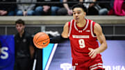 Feb 15, 2025; West Lafayette, Indiana, USA; Wisconsin Badgers guard John Tonje (9) dribbles the ball down the court during the first half against the Purdue Boilermakers at Mackey Arena. Mandatory Credit: Marc Lebryk-Imagn Images