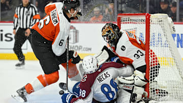 Dec 7, 2025; Philadelphia, Pennsylvania, USA; Colorado Avalanche center Martin Necas (88) crashes into Philadelphia Flyers goaltender Samuel Ersson (33) during the second period at Xfinity Mobile Arena. Mandatory Credit: Eric Hartline-Imagn Images