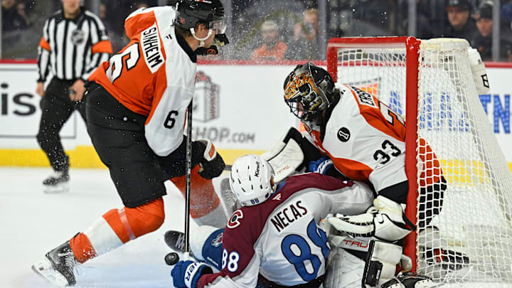 Dec 7, 2025; Philadelphia, Pennsylvania, USA; Colorado Avalanche center Martin Necas (88) crashes into Philadelphia Flyers goaltender Samuel Ersson (33) during the second period at Xfinity Mobile Arena. Mandatory Credit: Eric Hartline-Imagn Images