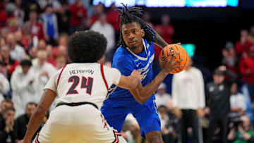 Mar 20, 2025; Lexington, KY, USA; Creighton Bluejays guard Jamiya Neal (5) handles the ball against Louisville Cardinals guard Chucky Hepburn (24) during the second half in the first round of the NCAA Tournament at Rupp Arena. Mandatory Credit: Aaron Doster-Imagn Images