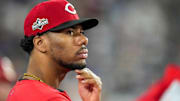 Cincinnati Reds pitcher Hunter Greene (21) watches from the dugout in the eighth inning of the MLB National League Wild Card Game 2 between the Los Angeles Dodgers and the Cincinnati Reds at Dodger Stadium in Los Angeles on Wednesday, Oct. 1, 2025. The Reds were eliminated from the postseason with an 8-4 loss to the reining World Series Champions La Dodgers.
