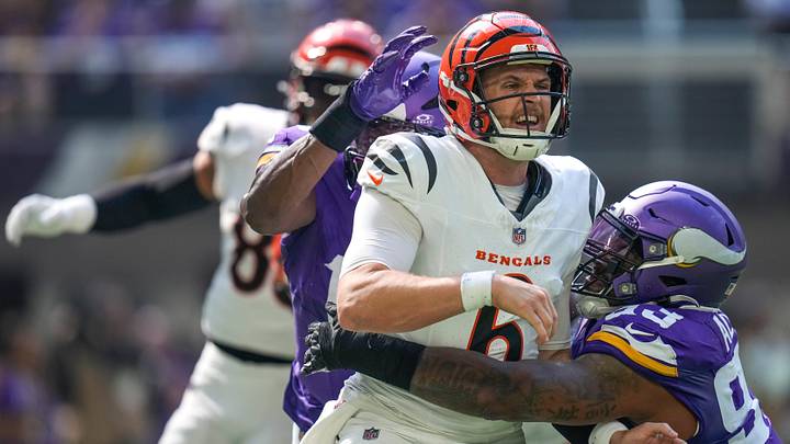 Cincinnati Bengals quarterback Jake Browning (6) is knocked down by Minnesota Vikings defensive tackle Jonathan Allen (93) as he gets a pass off in the second quarter of the NFL Week 3 game between the Minnesota Vikings and the Cincinnati Bengals at U.S. Bank Stadium in Minneapolis on Sunday, Sept. 21, 2025.