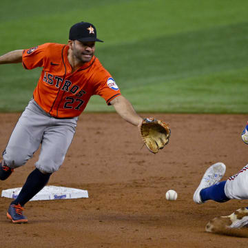 Aug 7, 2024; Arlington, Texas, USA;  Texas Rangers third baseman Josh Jung (6) advances to second base as Houston Astros second baseman Jose Altuve (27) cannot field the throw during the second inning at Globe Life Field. Mandatory Credit: Jerome Miron-USA TODAY Sports