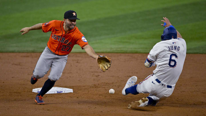 Aug 7, 2024; Arlington, Texas, USA;  Texas Rangers third baseman Josh Jung (6) advances to second base as Houston Astros second baseman Jose Altuve (27) cannot field the throw during the second inning at Globe Life Field. Mandatory Credit: Jerome Miron-USA TODAY Sports