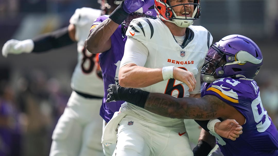 Cincinnati Bengals quarterback Jake Browning (6) is knocked down by Minnesota Vikings defensive tackle Jonathan Allen (93) as he gets a pass off in the second quarter of the NFL Week 3 game between the Minnesota Vikings and the Cincinnati Bengals at U.S. Bank Stadium in Minneapolis on Sunday, Sept. 21, 2025.