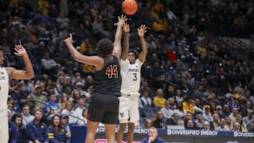 Nov 17, 2025; Morgantown, West Virginia, USA; West Virginia Mountaineers guard Honor Huff (3) shoots a three-point shot over Lafayette Leopards forward Shareef Jackson (44) during the second half at WVU Coliseum. Mandatory Credit: Ben Queen-Imagn Images
