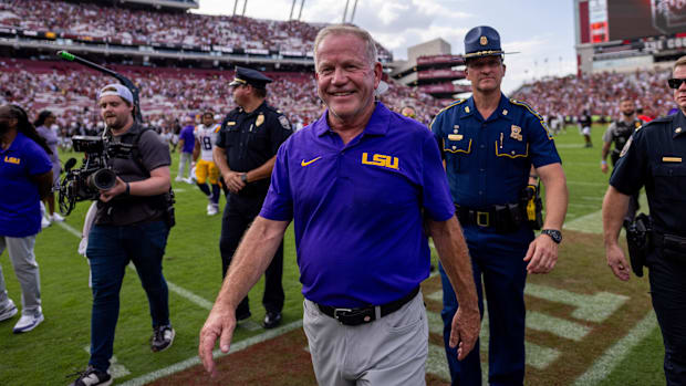 Brian Kelly smiles while walking off the field after LSU beat South Carolina