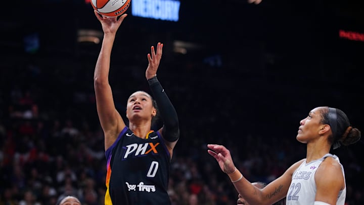 Mercury forward Satou Sabally (0) scores on an offensive rebound against Aces forward A’ja Wilson (22) during a game at PHX Arena in Phoenix, on Aug. 15, 2025.