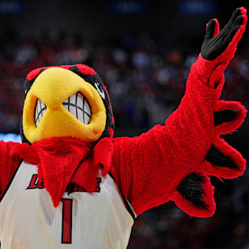 Mar 20, 2025; Lexington, KY, USA; The Louisville Cardinals mascot cheers during the second half against the Creighton Bluejays in the first round of the NCAA Tournament at Rupp Arena. Mandatory Credit: Aaron Doster-Imagn Images