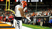 Cincinnati Bengals wide receiver Jermaine Burton (81) drops the ball on the ground after catching a touchdown pass in the fourth quarter of the NFL preseason game between the Cincinnati Bengals and the Indianapolis Colts at Paycor Stadium in Cincinnati on Thursday, Aug. 22, 2024.