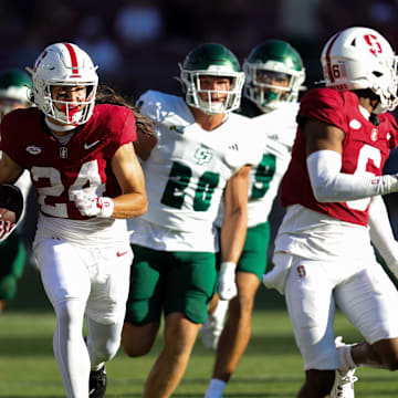 Sep 7, 2024; Stanford, California, USA; Stanford Cardinal wide receiver Tiger Bachmeier (24) returns a punt for a touchdown against the Cal Poly Mustangs during the second half at Stanford Stadium. Mandatory Credit: Sergio Estrada-Imagn Images