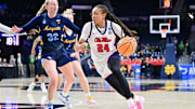 Mar 23, 2024; South Bend, Indiana, USA; Ole Miss Rebels forward Madison Scott (24) drives to the basket as Marquette Golden Eagles forward Liza Karlen (32) defends in the first half at the Purcell Pavilion. Mandatory Credit: Matt Cashore-Imagn Images