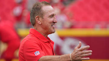 Aug 22, 2024; Kansas City, Missouri, USA; Kansas City Chiefs defensive coordinator Steve Spagnuolo greets a friend on field during warm ups against the Chicago Bears prior to a game at GEHA Field at Arrowhead Stadium. Mandatory Credit: Denny Medley-Imagn Images