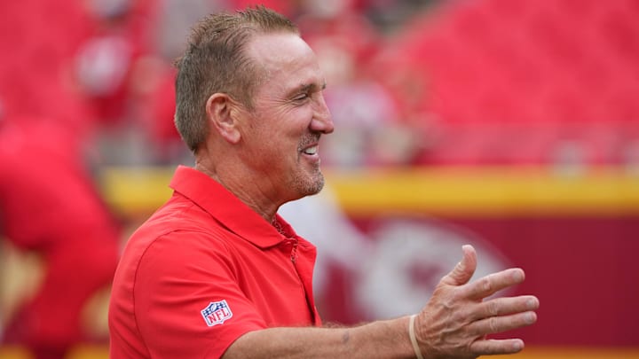 Aug 22, 2024; Kansas City, Missouri, USA; Kansas City Chiefs defensive coordinator Steve Spagnuolo greets a friend on field during warm ups against the Chicago Bears prior to a game at GEHA Field at Arrowhead Stadium. Mandatory Credit: Denny Medley-Imagn Images
