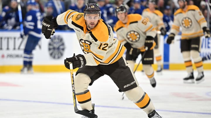 Dec 2, 2023; Toronto, Ontario, CAN; Boston Bruins defenseman Kevin Shattenkirk (12) pursues the puck against the Toronto Maple Leafs in the third period at Scotiabank Arena. Mandatory Credit: Dan Hamilton-USA TODAY Sports