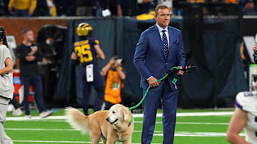 Jan 8, 2024; Houston, TX, USA; ESPN analyst  Kirk Herbstreit walks his dog Ben before the 2024 College Football Playoff national championship game between the Michigan Wolverines and the Washington Huskies at NRG Stadium. Mandatory Credit: Kirby Lee-Imagn Images