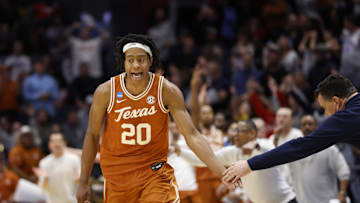 Mar 19, 2025; Dayton, OH, USA; Texas Longhorns guard Tre Johnson (20) high fives Xavier Musketeers head coach Sean Miller after making a three point basket in the second half at UD Arena. Mandatory Credit: Rick Osentoski-Imagn Images