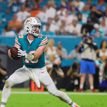 Miami Dolphins quarterback Skylar Thompson (19) fakes a handoff to running back De'Von Achane (28) during the fourth quarter at Hard Rock Stadium on Thursday night.