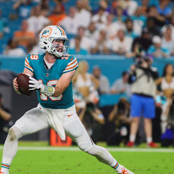 Miami Dolphins quarterback Skylar Thompson (19) fakes a handoff to running back De'Von Achane (28) during the fourth quarter at Hard Rock Stadium.