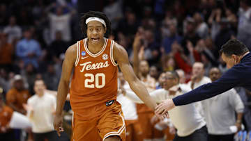 Mar 19, 2025; Dayton, OH, USA; Texas Longhorns guard Tre Johnson (20) high fives Xavier Musketeers head coach Sean Miller after making a three point basket in the second half at UD Arena. Mandatory Credit: Rick Osentoski-Imagn Images