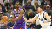 Feb 11, 2023; Sacramento, California, USA; Sacramento Kings forward Harrison Barnes (40) handles the ball against Dallas Mavericks guard Luka Doncic (77) during the first quarter at Golden 1 Center. Mandatory Credit: Darren Yamashita-USA TODAY Sports