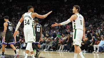 Mar 22, 2025; Sacramento, California, USA; Milwaukee Bucks forward Giannis Antetokounmpo (34) and center Brook Lopez (11) celebrate after defeating the Sacramento Kings at Golden 1 Center. Mandatory Credit: Darren Yamashita-Imagn Images