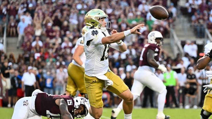 Aug 31, 2024; College Station, Texas, USA; Notre Dame Fighting Irish quarterback Riley Leonard (13) throws a pass under pressure from Texas A&M Aggies quarterback Conner Weigman (15) during the first quarter at Kyle Field. Mandatory Credit: Maria Lysaker-USA TODAY Sports