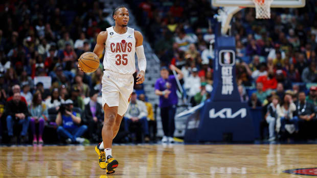 Isaac Okoro dribbles the ball up the floor