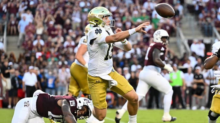 Aug 31, 2024; College Station, Texas, USA; Notre Dame Fighting Irish quarterback Riley Leonard (13) throws a pass under pressure from Texas A&M Aggies quarterback Conner Weigman (15) during the first quarter at Kyle Field. Mandatory Credit: Maria Lysaker-USA TODAY Sports