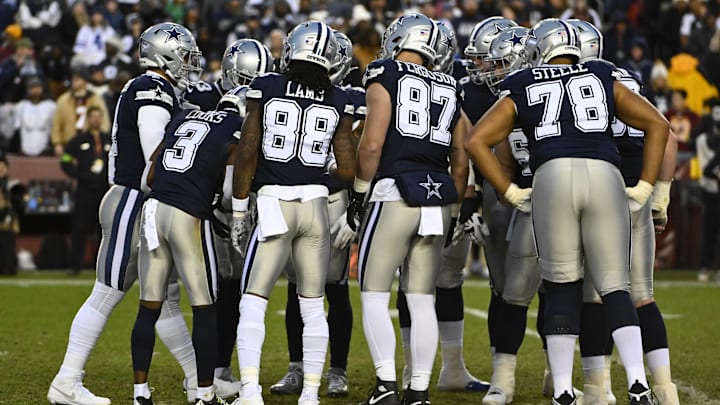 Dallas Cowboys huddle against the Washington Commanders during the first half at FedExField.