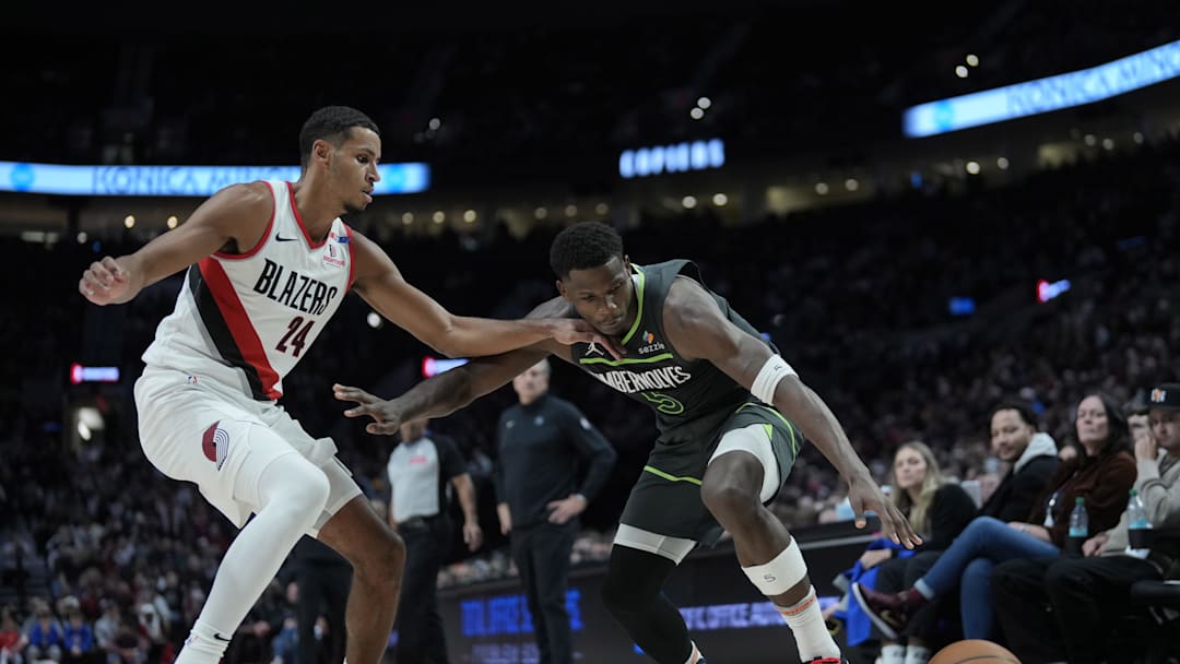 Nov 13, 2024; Portland, Oregon, USA; Minnesota Timberwolves shooting guard Anthony Edwards (5) loses control of the ball against Portland Trail Blazers forward Kris Murray (24) during the second half at Moda Center. Mandatory Credit: Soobum Im-Imagn Images