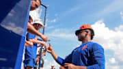 Feb 19, 2025; Port St. Lucie, FL, USA; New York Mets right fielder Juan Soto (22) signs autographs to fans during a spring training workout at Clover Park. Mandatory Credit: Sam Navarro-Imagn Images