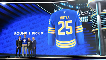 Jun 27, 2025; Los Angeles, California, USA; Radim Mrtka (second from left) poses with John Rzeznik (left) and Robby Takac (second from right) of the Goo Goo Dolls and NHL commissioner Gary Bettman (right) after being selected  as the ninth overall pick to the Buffalo Sabres in the first round of the 2025 NHL Draft at Peacock Theater. Mandatory Credit: Kirby Lee-Imagn Images