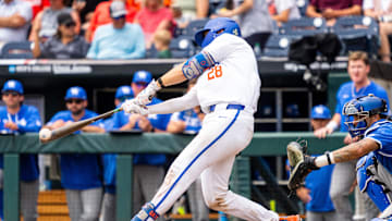 Jun 19, 2024; Omaha, NE, USA; Florida Gators catcher Luke Heyman (28) hits a double against the Kentucky Wildcats during the seventh inning at Charles Schwab Field Omaha. Mandatory Credit: Dylan Widger-Imagn Images
