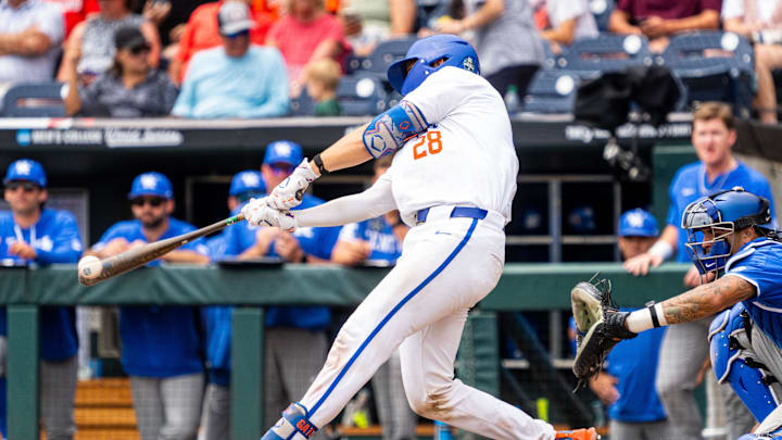 Jun 19, 2024; Omaha, NE, USA; Florida Gators catcher Luke Heyman (28) hits a double against the Kentucky Wildcats during the seventh inning at Charles Schwab Field Omaha. Mandatory Credit: Dylan Widger-Imagn Images