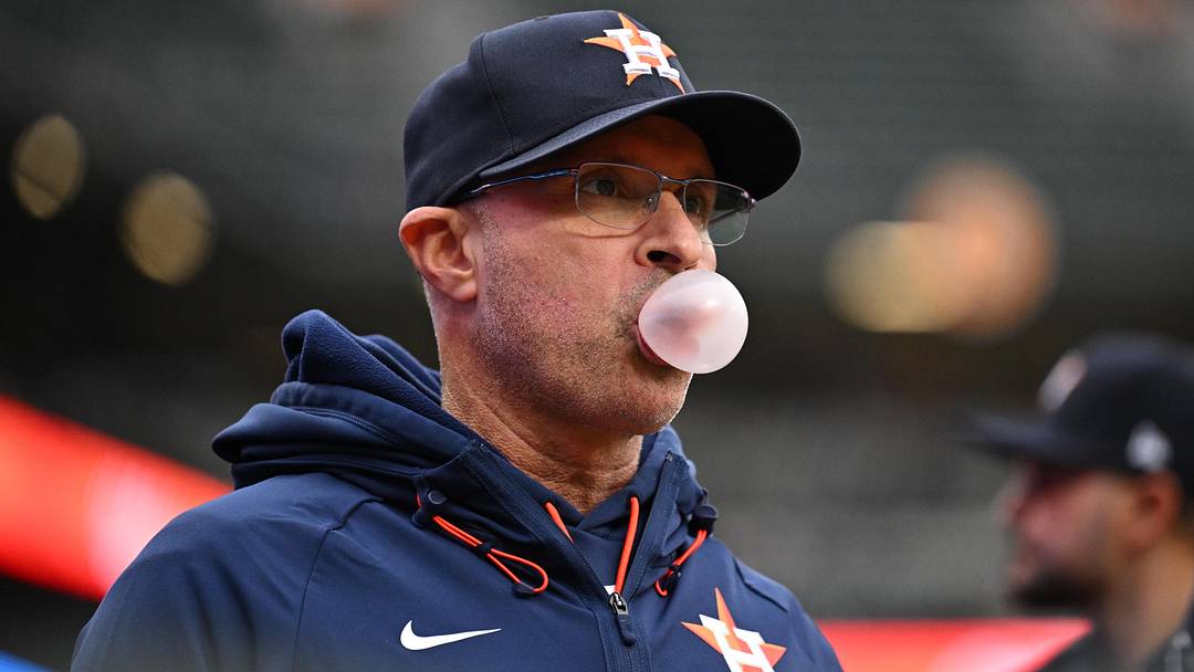 Apr 28, 2026; Baltimore, Maryland, USA;  Houston Astros manager Joe Espada (19) blows a bubble while waiting for the start of a game against the Baltimore Orioles at Oriole Park at Camden Yards. Mandatory Credit: Jamie Sabau-Imagn Images