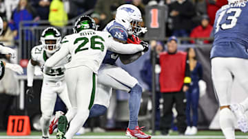 Nov 13, 2025; Foxborough, Massachusetts, USA; New England Patriots running back TreVeyon Henderson (32) scores a touchdown during the first half against the New York Jets at Gillette Stadium. Mandatory Credit: Eric Canha-Imagn Images