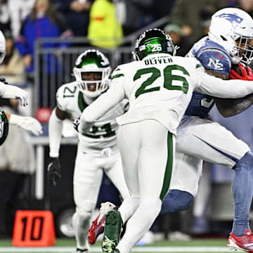 Nov 13, 2025; Foxborough, Massachusetts, USA; New England Patriots running back TreVeyon Henderson (32) scores a touchdown during the first half against the New York Jets at Gillette Stadium. Mandatory Credit: Eric Canha-Imagn Images