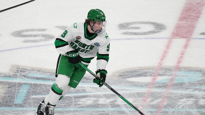 Apr 9, 2026; Las Vegas, Nevada, UNITED STATES; North Dakota Fighting Hawks forward Will Zellers (9) moves the puck in the second period against the Wisconsin Badgers in the semifinals of the NCAA men's ice hockey Frozen Four at T-Mobile Arena. Mandatory Credit: Lucas Peltier-Imagn Images